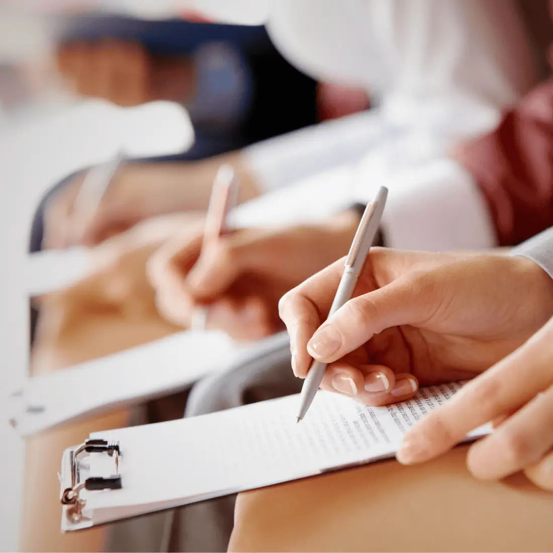 Hands taking notes during a training session