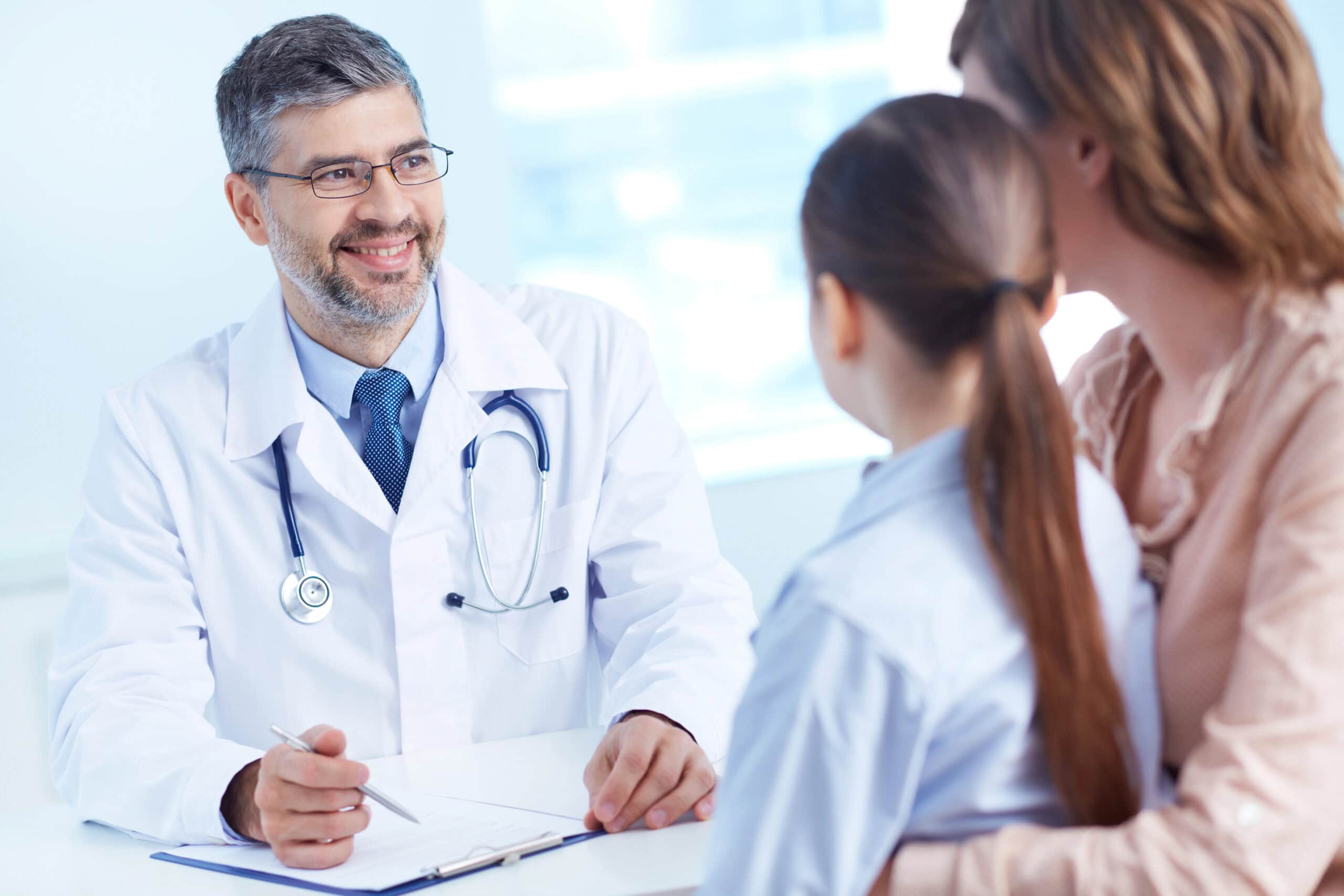 Optimized Stem Cell Care. Experienced doctor discussing treatment options with patients for regenerative medicine at Synergy.