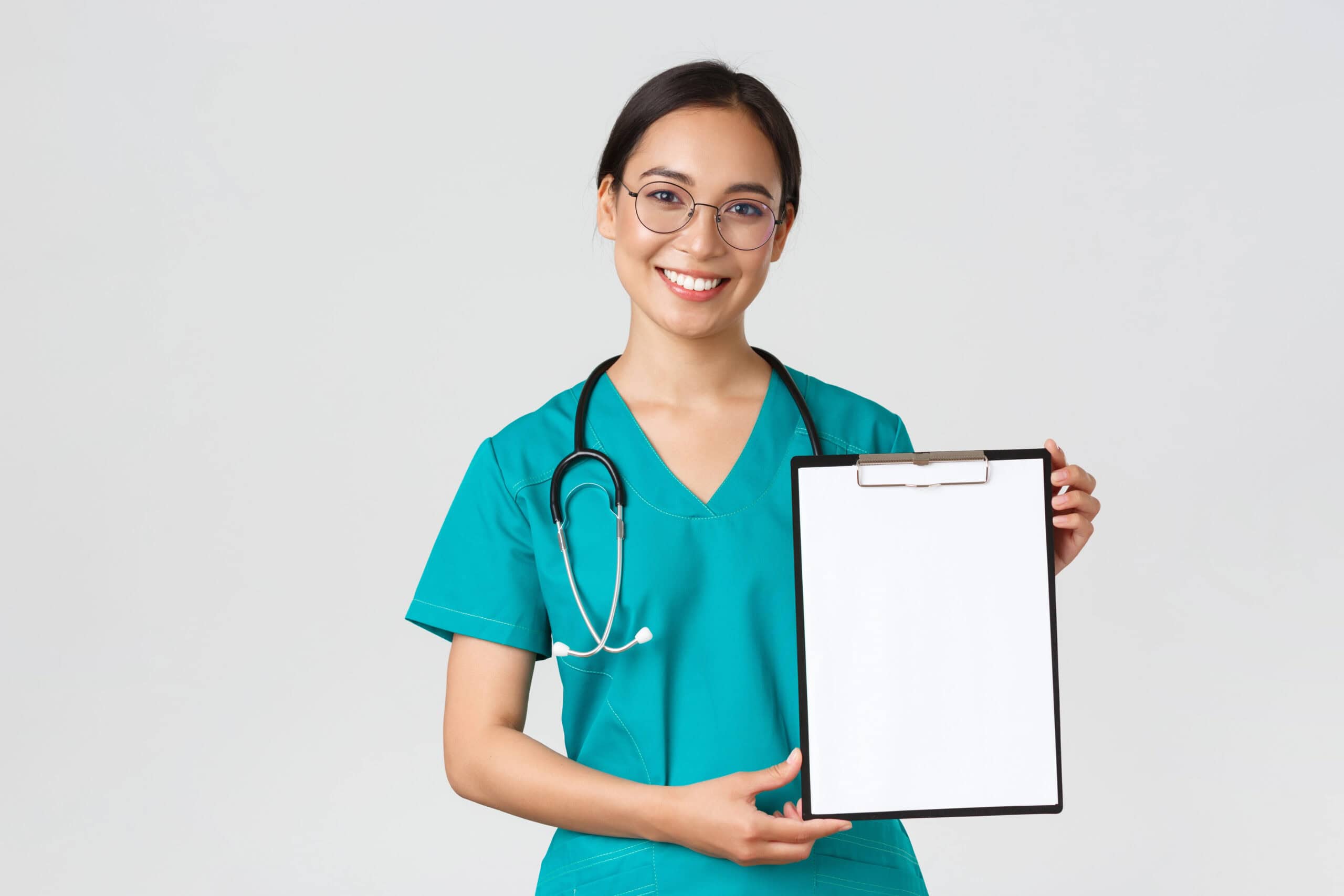 Female healthcare professional holding a blank clipboard, smiling, wearing teal scrubs with stethoscope. Focus on medical expertise and Optima.