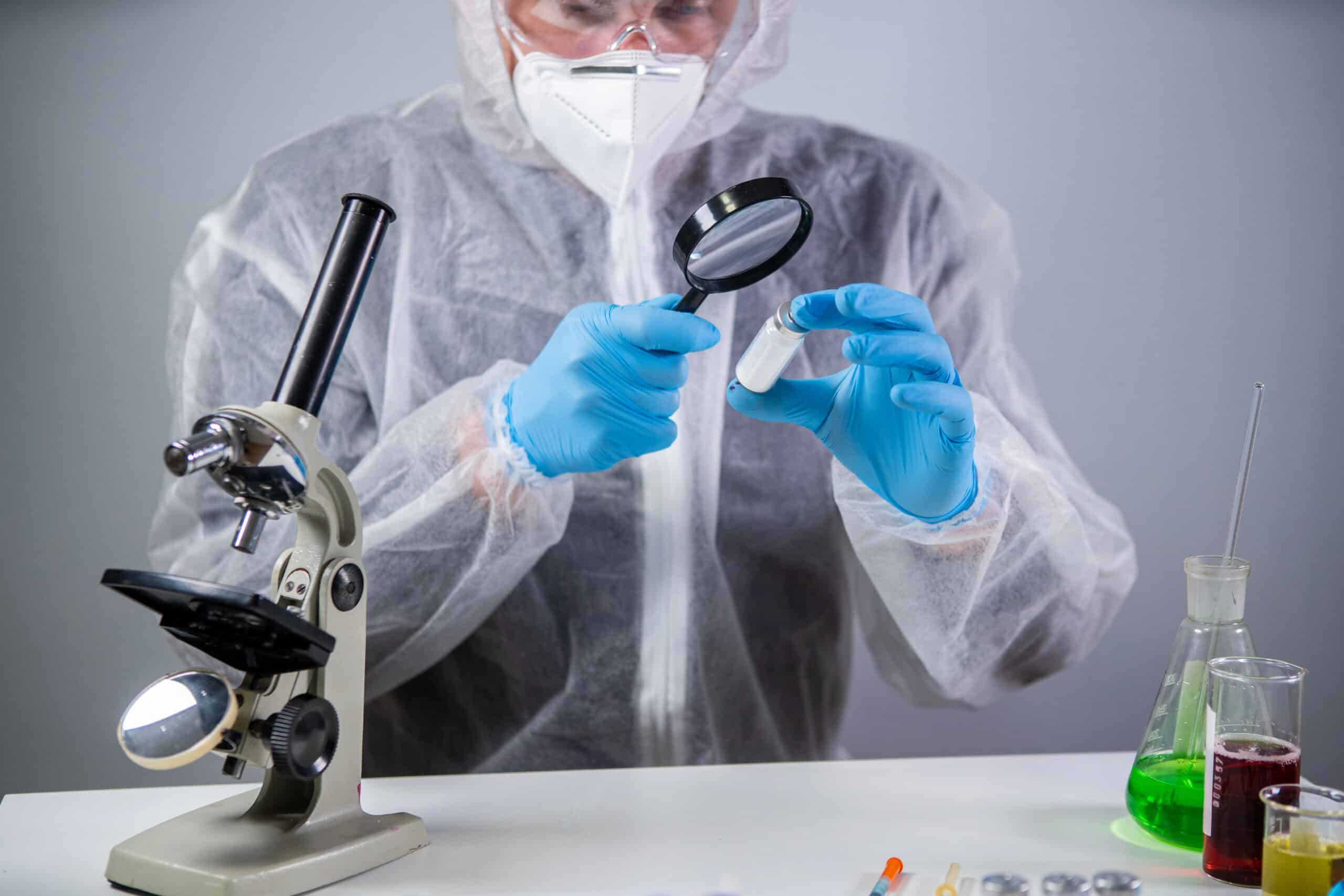 Microscope scientist examining stem cell sample with magnifying lens in laboratory setting.