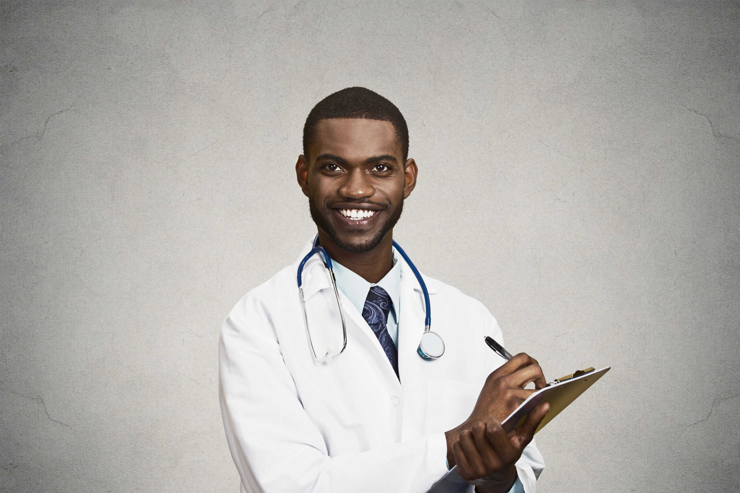 Doctor with stethoscope and clipboard, smiling, healthcare expert.